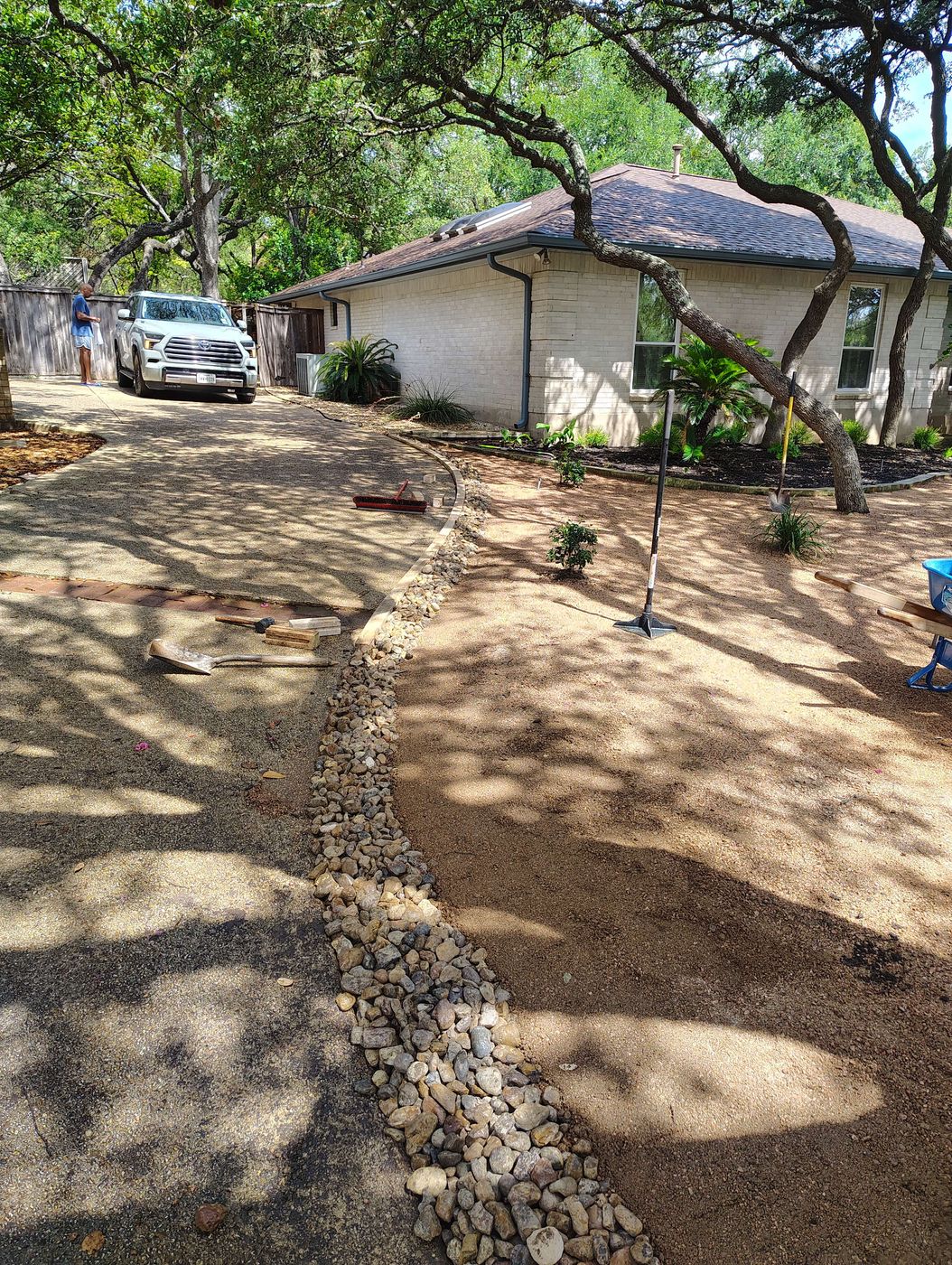 River-rock dry creek bed routing runoff away from house
